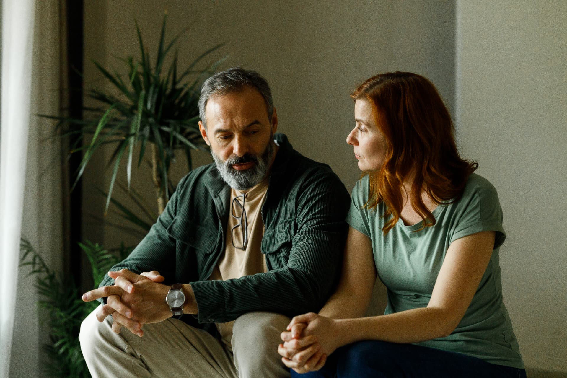 A couple sitting together talking about something difficult